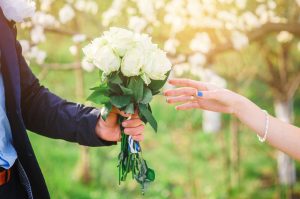 groom gives his bride a beautiful wedding bouquet.